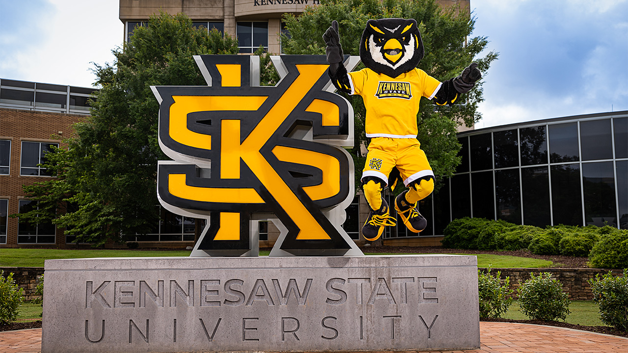Scrappy jumping off of KSU entrance sign